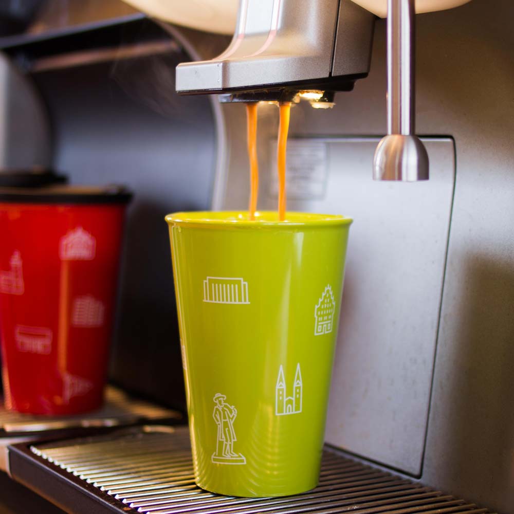 ORNAMIN-referenzen-bielefeld-to-go-verkaufstresen ORNAMIN Bielefeld To-go Becher unter einer Espressomaschine
